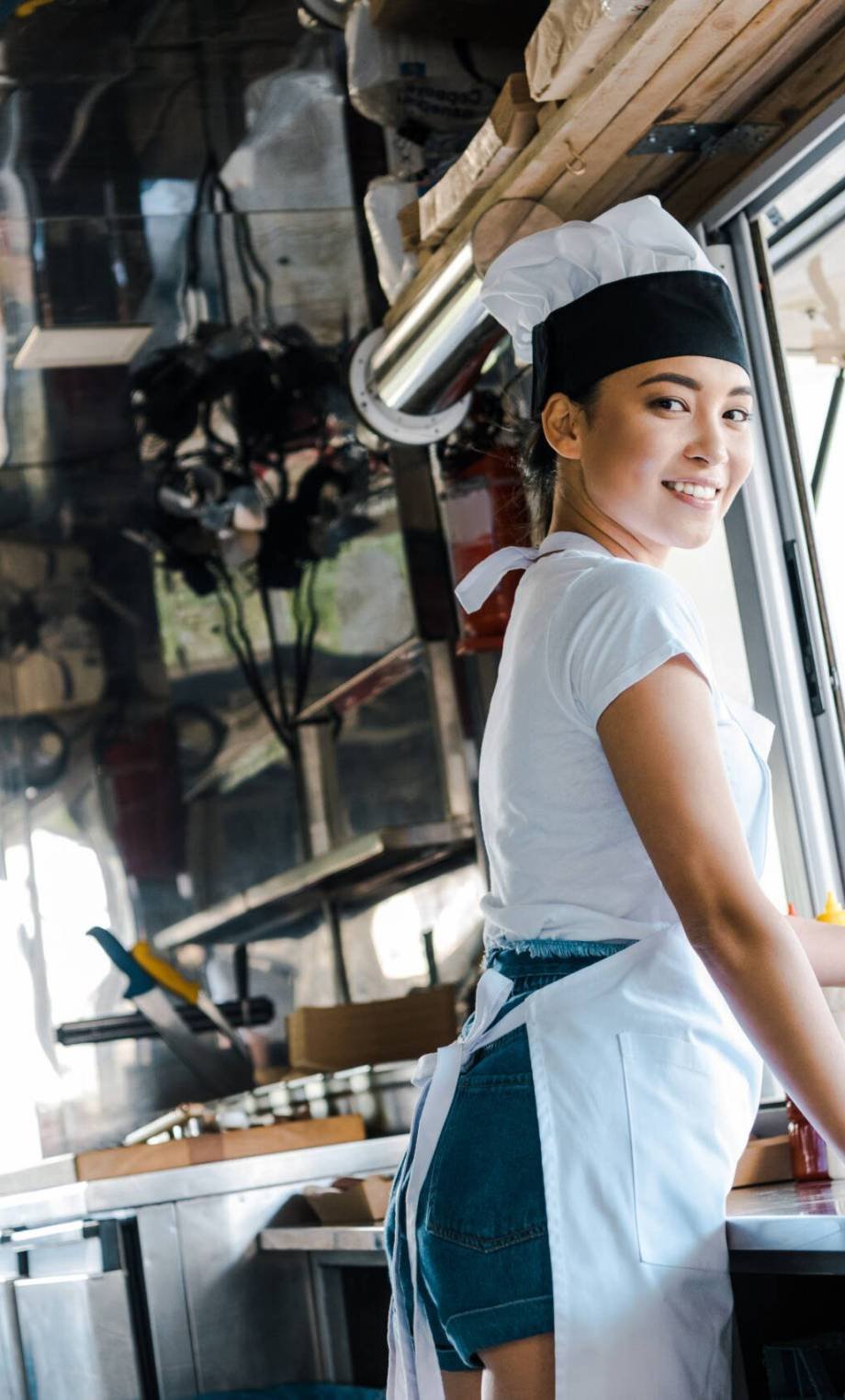 happy asian woman holding carton plate in food truck happy asian woman holding carton plate in food truck